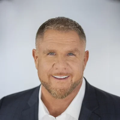 Lance Casazza smiling while wearing a suit.